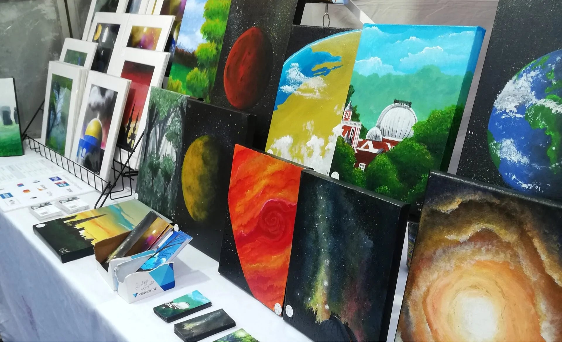Artworks from Ian Garrett Studios including paintings and photo frames.