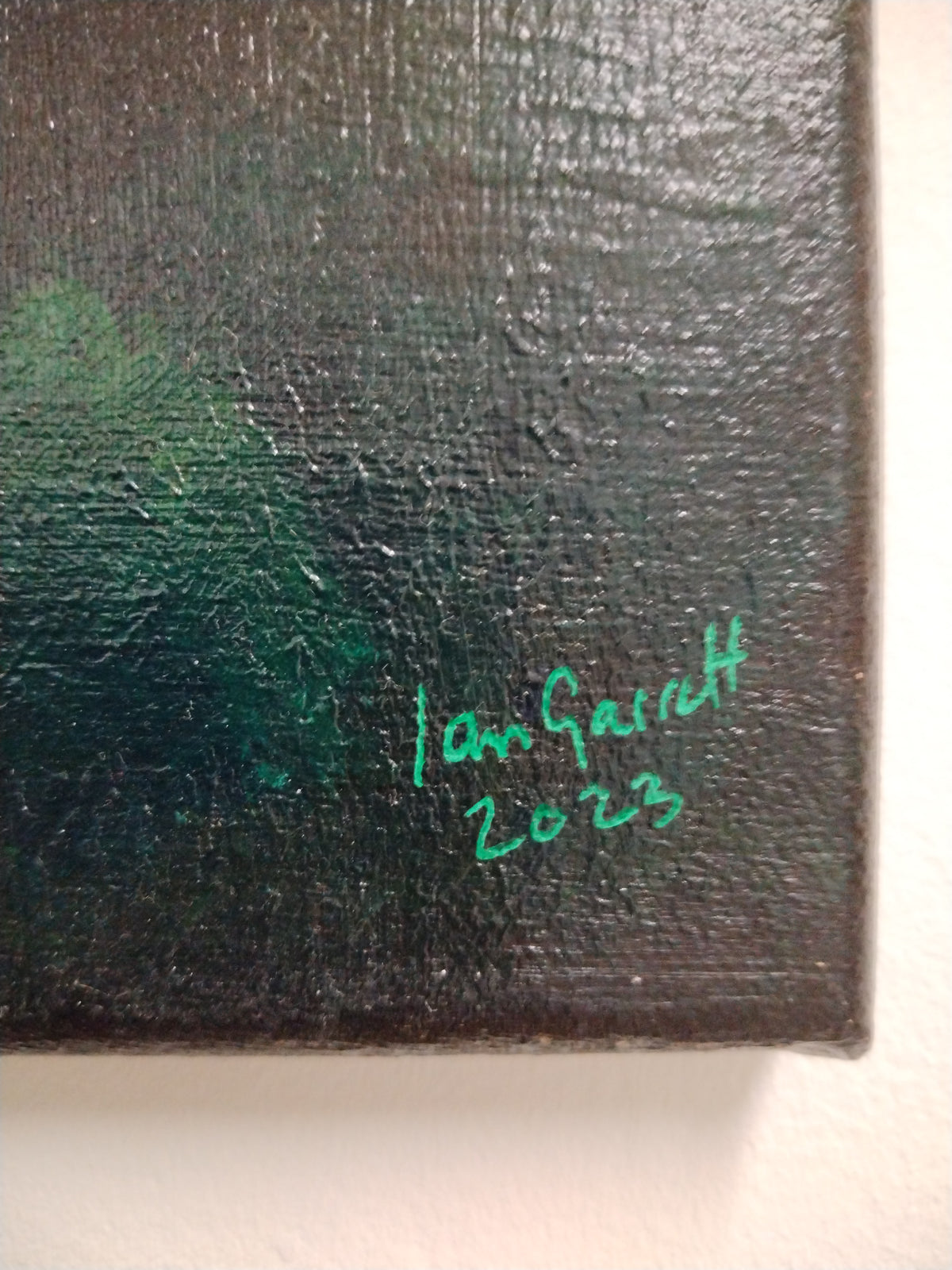 Close-up of the artist signature Ian Garrett 2023 on the painting of Greenwich Observatory under the new moon.