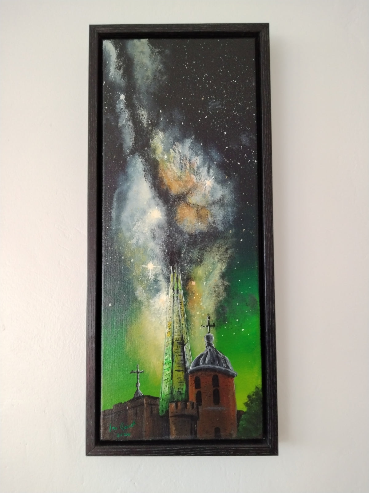 Acrylic painting of the Milkyway rising above the Shard and The Tower of London hung on a white wall.